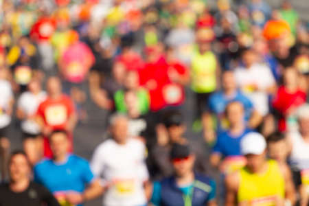 Crowd of runners run a marathon on the streetの写真素材