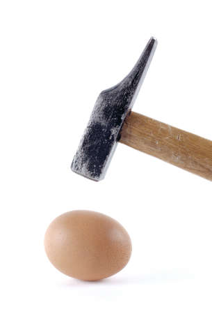Fragility and egg concept with caution and used a hammerの写真素材