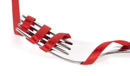 Fork with red ribbon threadedの写真素材