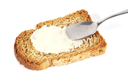 Toast with butter and spoonの写真素材