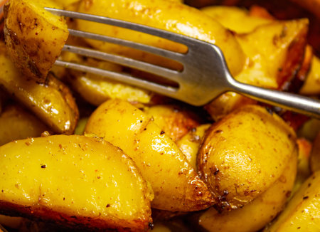 Fried potatoes with spices in a rustic way with a crispy crust, looks very appetizingの写真素材
