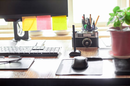Workplace of a freelance graphic designer at a computerの写真素材