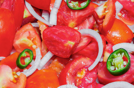 Salad made with organic tomatoes, onions and hot chili peppers, grown in the garden without the use of chemicalsの写真素材