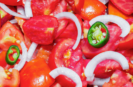 Salad made with organic tomatoes, onions and hot chili peppers, grown in the garden without the use of chemicalsの写真素材