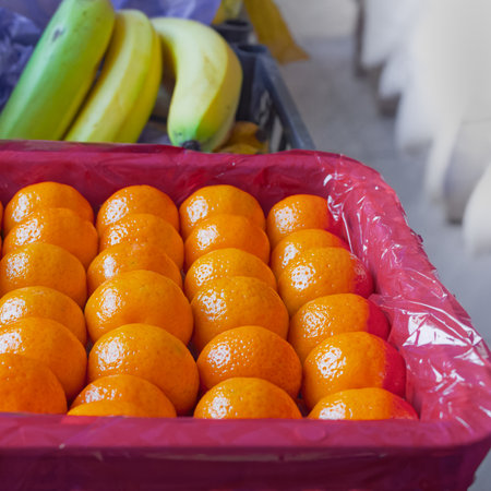 Fresh tangerines in boxes on the shelves of a grocery supermarket, tangerines on the shelves of a grocery storeの写真素材