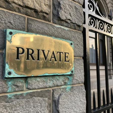 A gleaming brass sign with the word 'PRIVATE' is prominently displayed on a textured stone wall. Adjacent to it is an elegant, black wrought-iron gate, suggesting exclusivity and limited access.の素材