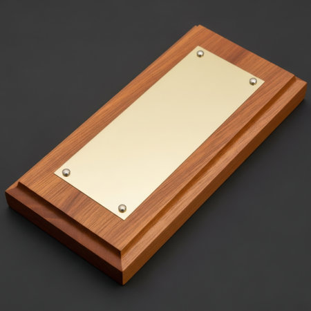 A distinguished wooden plaque featuring a blank polished brass plate, perfect for engraving custom awards, recognition plaques, and commemorative signage. Rich wood grain adds warmth and prestige.の素材