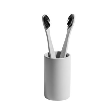 Eco-friendly bamboo toothbrushes in a sleek gray holder, perfect for a minimalist bathroom. Sustainable oral hygiene solution for everyday use and travel.の素材