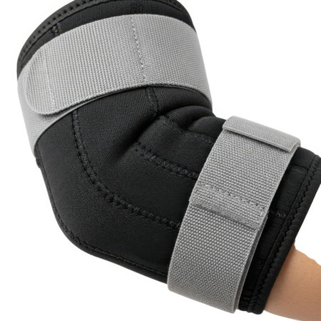 A black elbow brace with adjustable gray straps is worn on a person's arm, isolated on a white background.の素材
