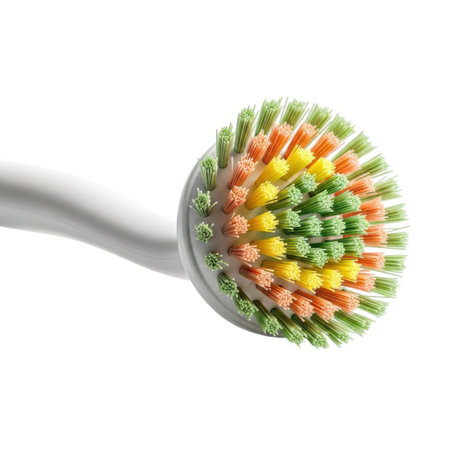 A detailed view of a round cleaning brush head with vibrant multicolored bristles, isolated on a clean white background.の素材