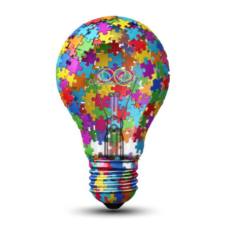 This image features a light bulb filled with an assortment of brightly colored puzzle pieces, symbolizing a bright idea on a white background.の素材