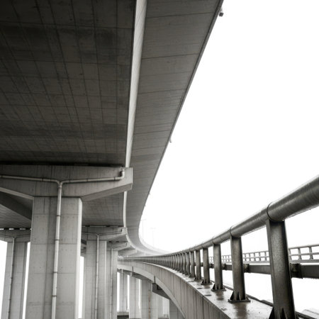 A low angle view of a concrete elevated highway structure with railings, isolated on a white background.の素材