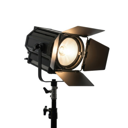 A powerful studio spotlight with four adjustable barn doors, mounted on a stand, isolated on a clean white background.の素材