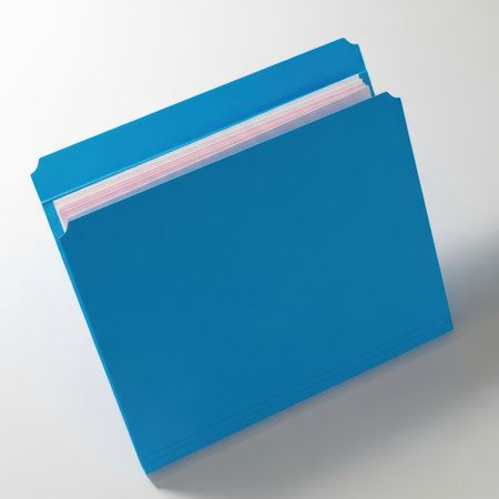 A bright blue folder is slightly open, revealing stacked papers inside. The image is captured from an angled perspective, showing the texture of the folder and the smooth paper.の素材
