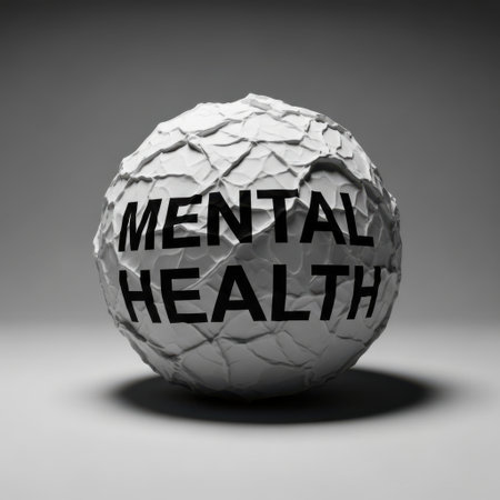 A close-up, grayscale shot of a crumpled paper sphere with the words mental health printed on it. The sphere casts a soft shadow.の素材