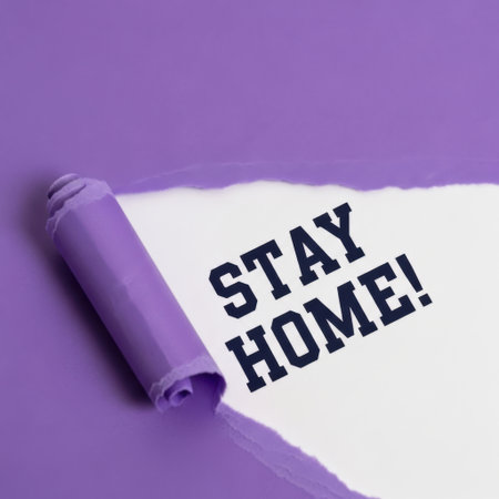 A bold "STAY HOME!" message is revealed as purple paper is torn back, highlighting a call for safety and well-being.の素材