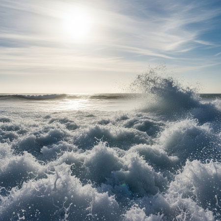 A powerful ocean wave breaks with foamy crests, illuminated by the sun's brilliant light. The shimmering water and dynamic movement capture the raw energy of the sea.の素材