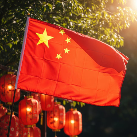 A bright red Chinese national flag with yellow stars flutters gracefully. Behind it, glowing red lanterns and lush green foliage are illuminated by warm sunlight, creating a festive and patriotic scene.の素材