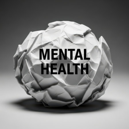A close-up, grayscale image of a crumpled paper ball with the words 'MENTAL HEALTH' printed on it. This visual metaphor represents the complexity and struggles associated with mental well-being and psychological state.の素材