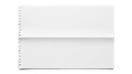 This studio shot captures a blank piece of white paper, neatly folded horizontally in the middle. The left edge of the paper features the characteristic perforated holes, indicating it was torn from a spiral-bound notebook or legal pad. The paper is presented against a stark white background, creating a minimalist and clean composition that highlights the texture and form of the paper itself.の素材