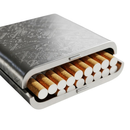 A close-up view of a metal cigarette holder containing many cigarettes, all isolated on a clean white background.の素材