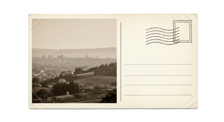 This image depicts a vintage postcard featuring a scenic cityscape. The photograph is in sepia tone, capturing a panoramic view of a town or city with numerous buildings and structures. The postcard includes a postmark and cancellation marks, indicating it has been mailed. The image evokes a sense of nostalgia and historical charm.の素材