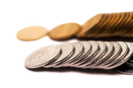 Scattered coins on a white backgroundの写真素材