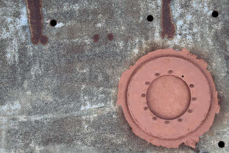grunge rusty metal sheet with manholeの写真素材