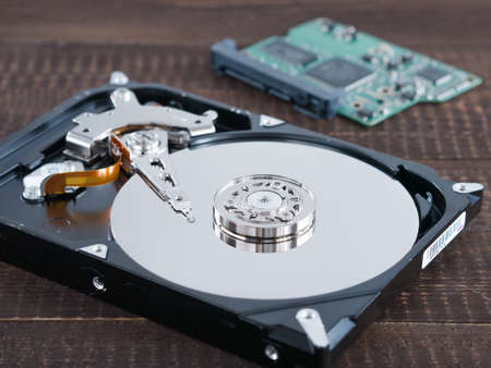 open hard disk drive (HDD) on dark wooden background