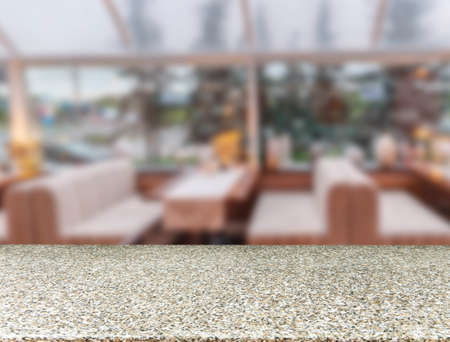 Marble board empty table in front of blurred background. Perspective marble table over blur in cafe interior - can be used for display or montage your products. Mockup your productsの写真素材