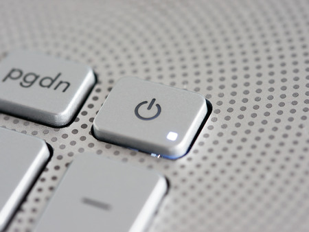 Silver laptop power button close up. Shallow DOFの写真素材