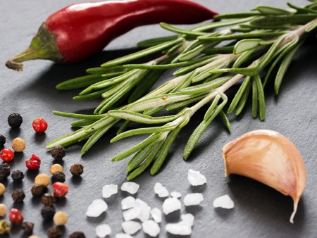 Herbs and spices over slate background. Top view or flat lay. Food backgroundの写真素材