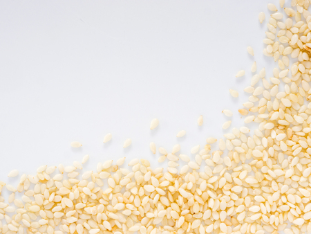 Sesame Seeds on white background with copy space. Isolated one edge. Top view or flat lay.の写真素材