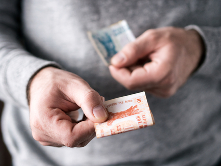 Hands hold Moldovan leu. Selective focus. Shallow DOFの写真素材