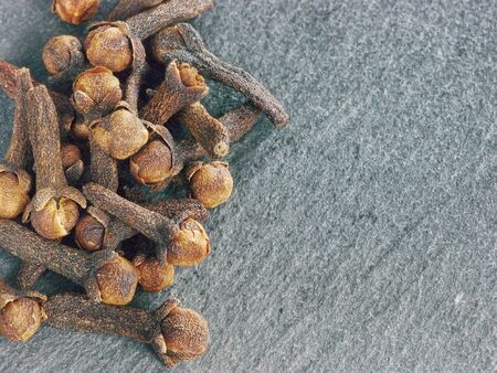 Cloves spice on gray slate background, copy spaceの写真素材