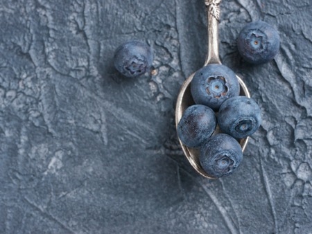 Blueberries in spoon on dark backgroundの写真素材