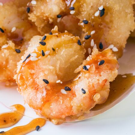 Japanese cuisine - fried tempura shrimps isolated on whiteの写真素材