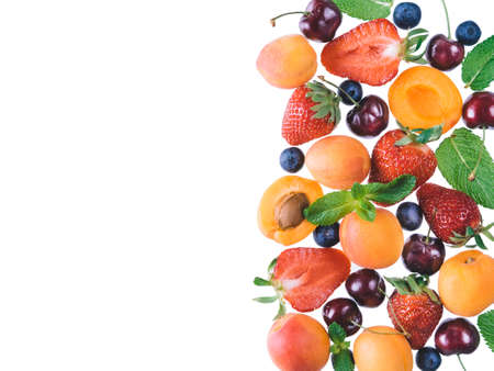 Apricot, strawberries, cherry, blueberries and mint leaves isolated on white background with copy space. Food background, mix of berries, healthy food, superfood, diet, detox concept. Top viewの写真素材
