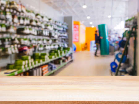 Empty table in front of blurred DIY supermarkeの写真素材