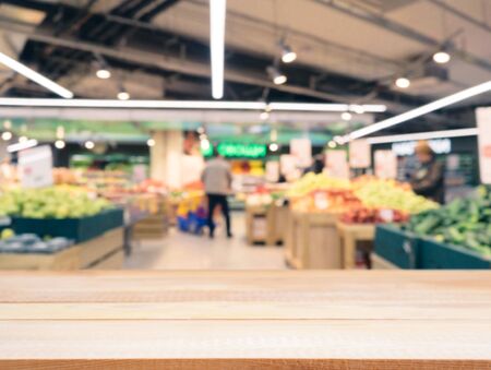 Light wooden board empty table in front of blurred background. Perspective light wood over blur in supermarket - can be used for display or montage your products. Mockup for display of product.の写真素材