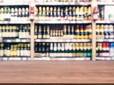 Brown wooden board empty table in front of blurred background. Perspective white wood over blur in supermarket - can be used for display or montage your products. Mockup for display of product.の写真素材