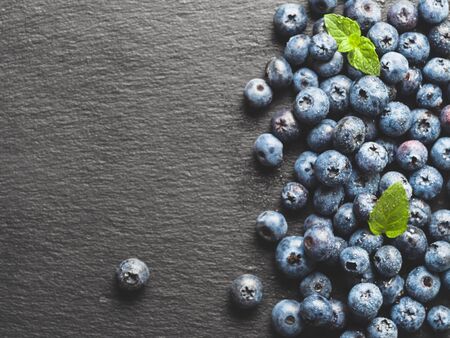 blueberries on gray slate background, top view, copy spaceの写真素材