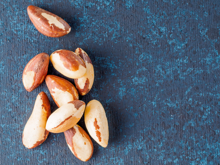 Macadamia nut or brasil nut on dark blue background with copy space Top view or flat-lay.の写真素材