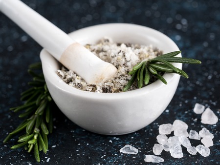 Sea salt scented herb rosemary on dark blue backgroundの写真素材