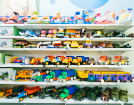 Blurred of kids toy store background with bokhe. shelves with toy cars in kids toy shop interior, copy spaceの写真素材