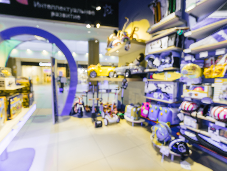 Blurred of kids toy store background with bokhe. Purple and yellow colors of toys shop interior, copy spaceの写真素材
