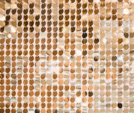 Golden sequins - sparkling sequined texture. Can use as background. Copy spaceの写真素材