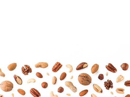 Pattern of nuts mix with copy space. Various nuts isolated on white. Pecan, macadamia, brazil nut, walnut, almonds, hazelnuts, pistachios, cashews, peanuts, pine nuts. Top view or flat-lay. Copy spaceの写真素材