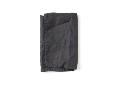 Folded dark black linen napkin isolated on white background. Anthracite grey linen napkin. Isolated on white with clipping path. Top view or flat lay.の写真素材