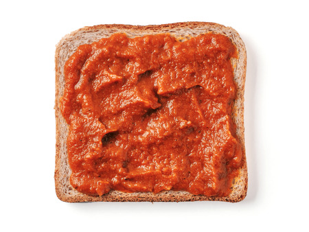 Bread slice with ketchup isolated on whiteの写真素材